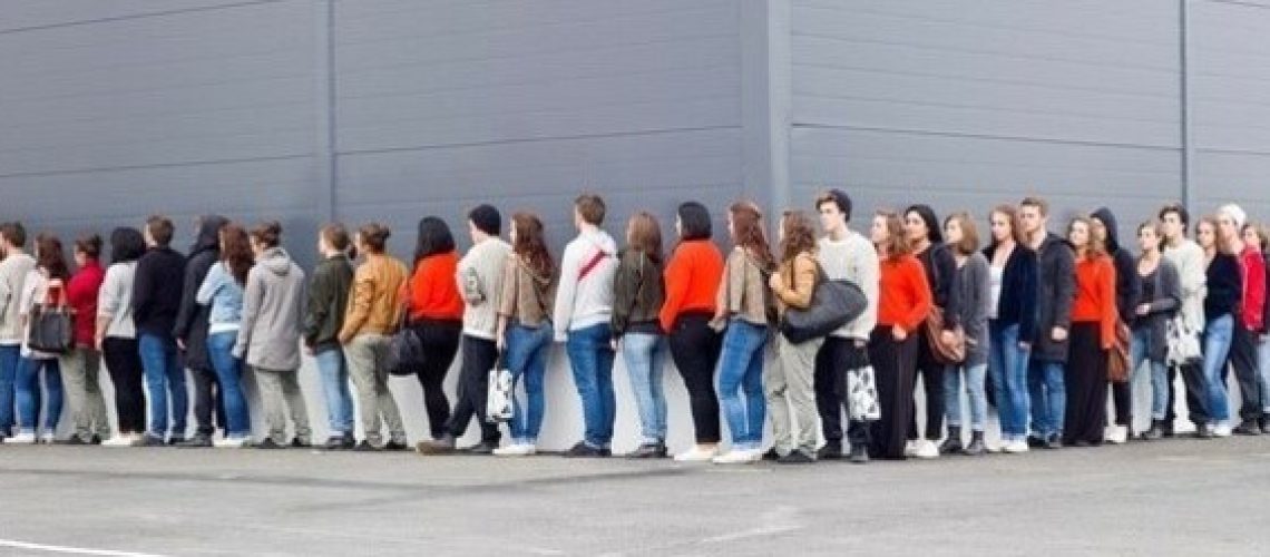 Large group of people waiting in line